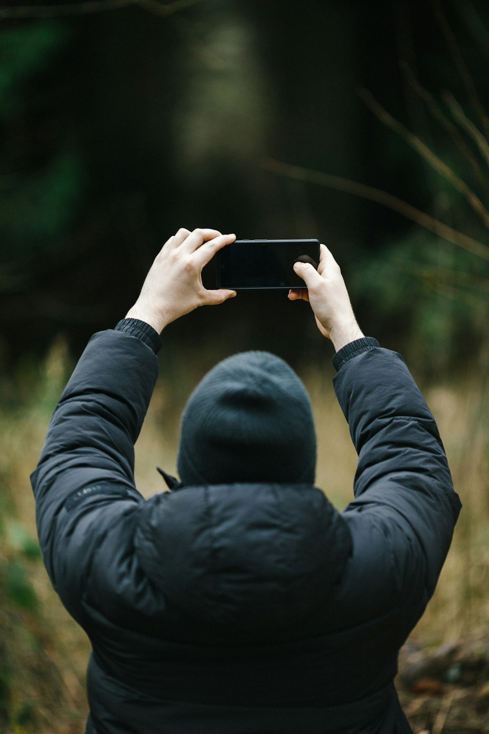 a person taking a picture with a cell phone