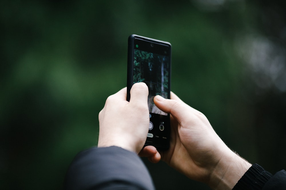 a person taking a picture with a cell phone