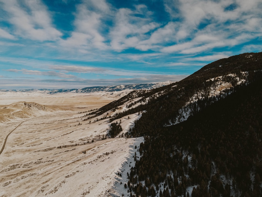 a snow covered mountain with a road going through it