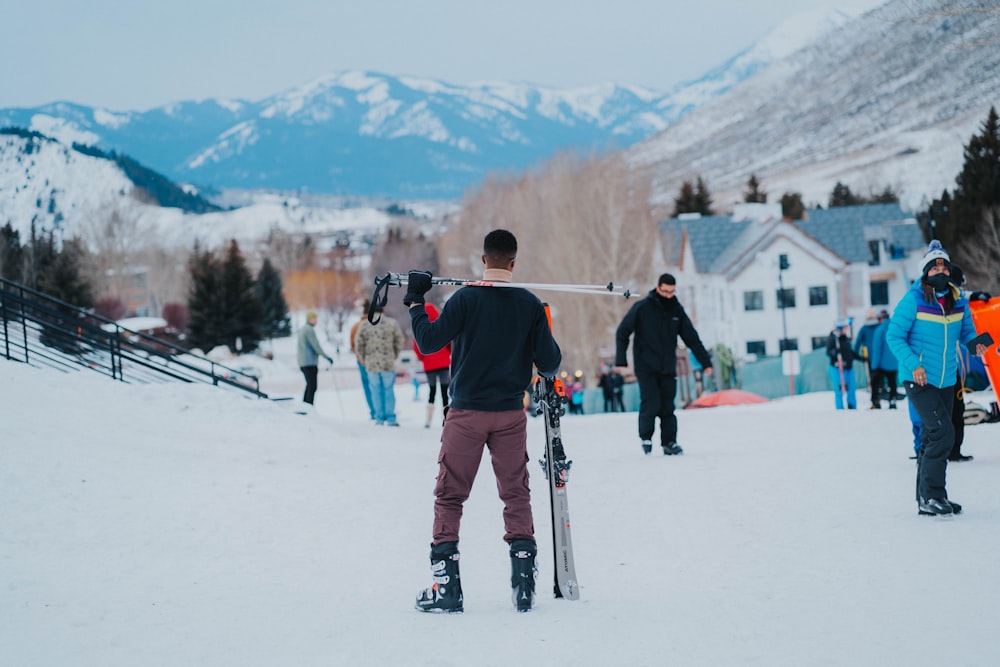 a group of people standing on top of a snow covered slope