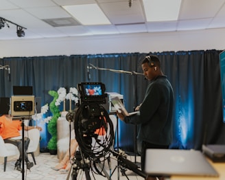 a man standing in front of a camera in a room