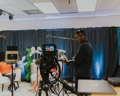 a man standing in front of a camera in a room