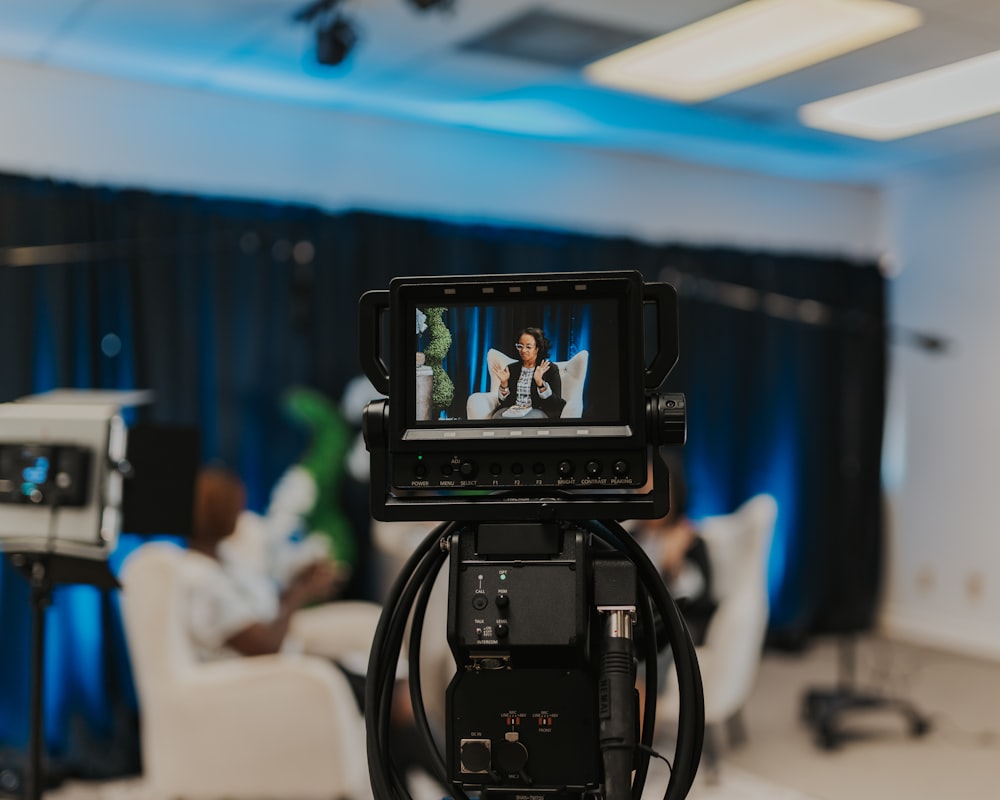 a camera set up in a room with people in the background