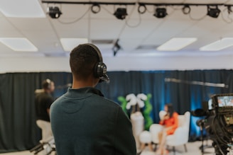 a man wearing headphones in front of a camera