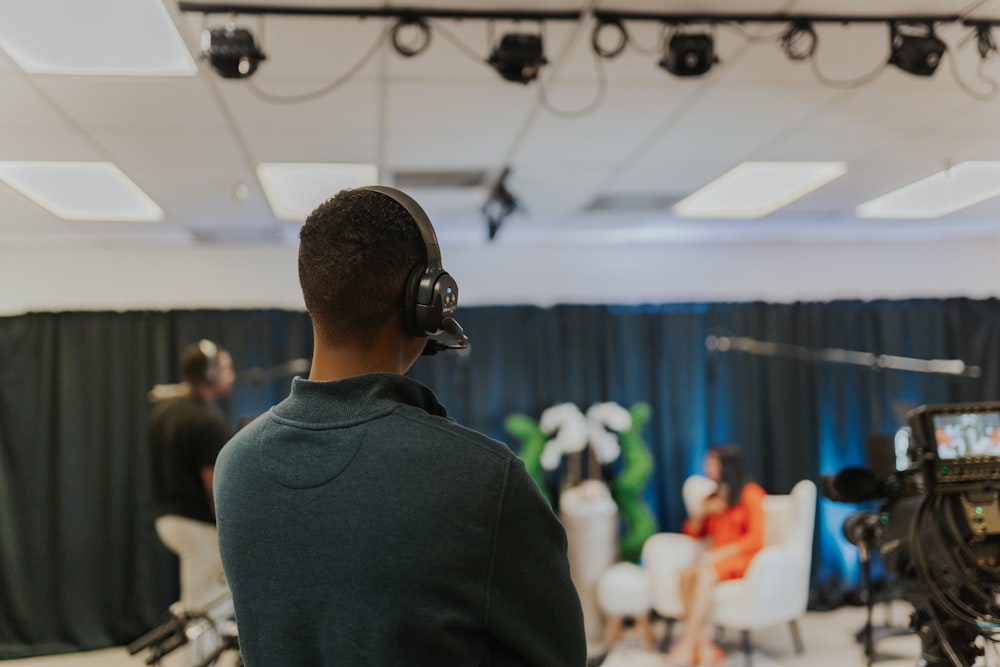 a man wearing headphones in front of a camera