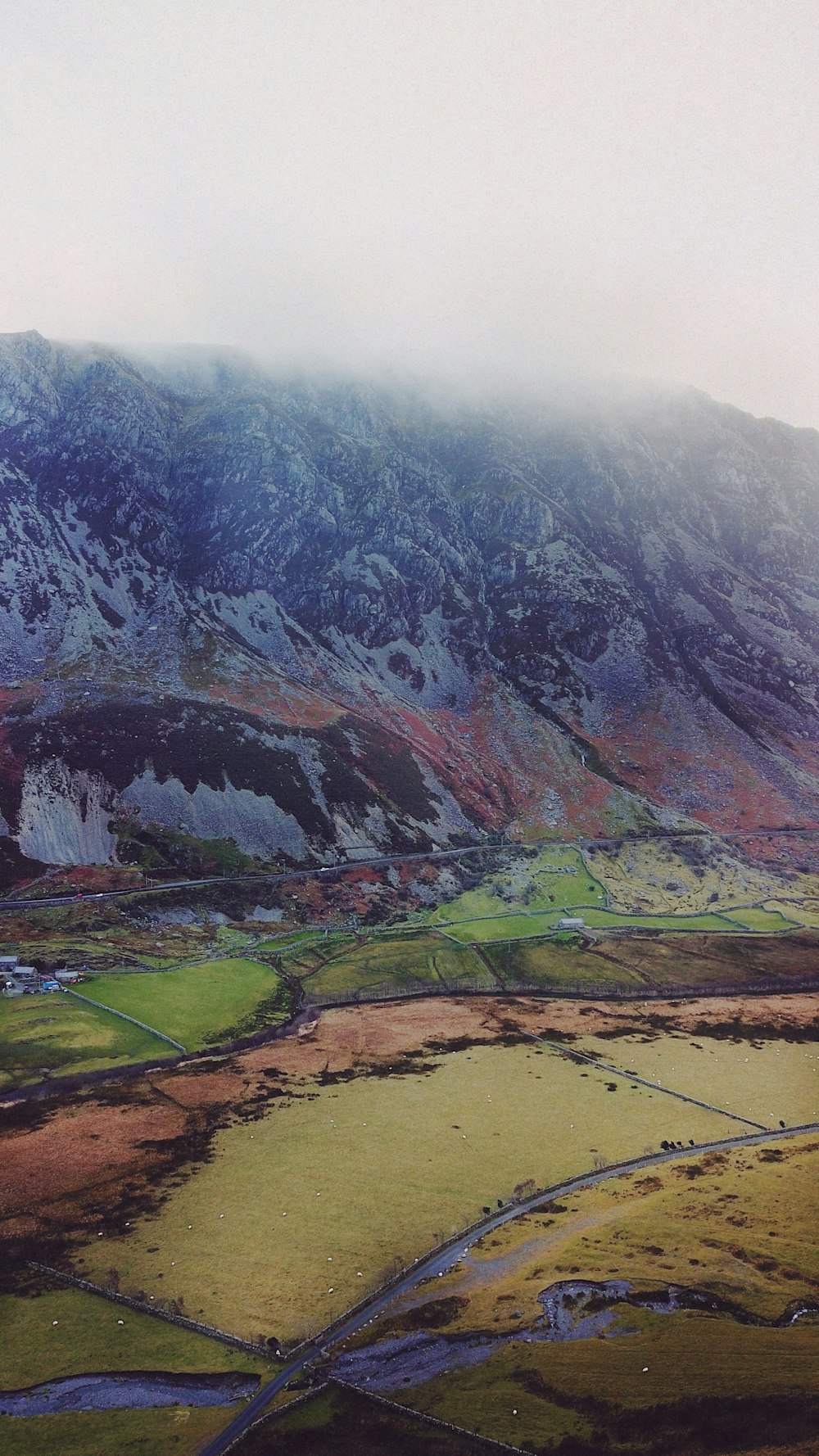 an aerial view of a mountain range with a river running through it