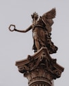 a statue of an angel on top of a building
