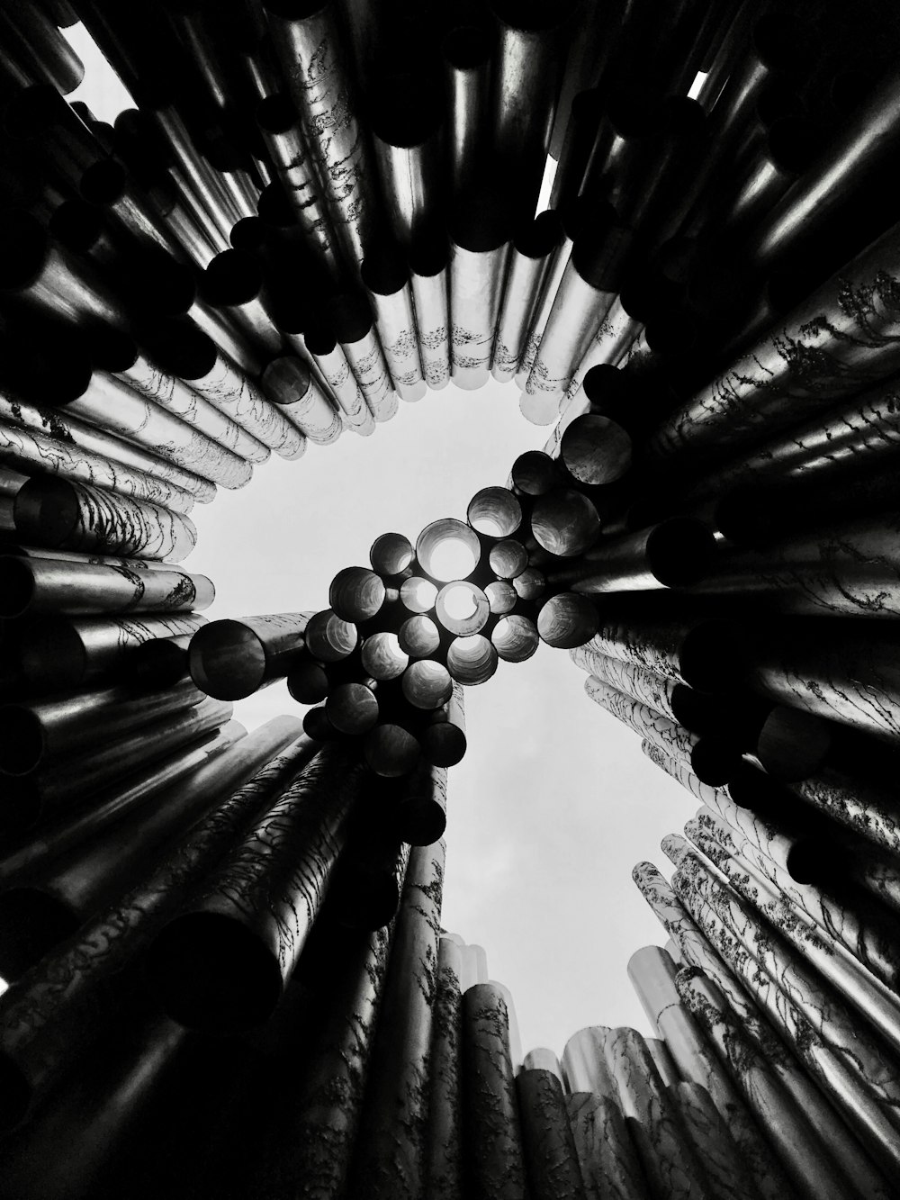 looking up at a bunch of metal pipes