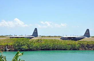 Cargo planes lined up on a clear runway preparing for international air shipment.