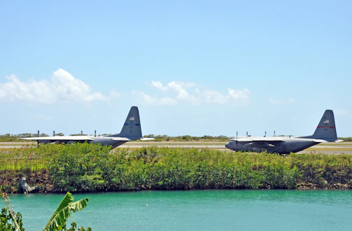 Cargo planes lined up on a clear runway preparing for international air shipment.