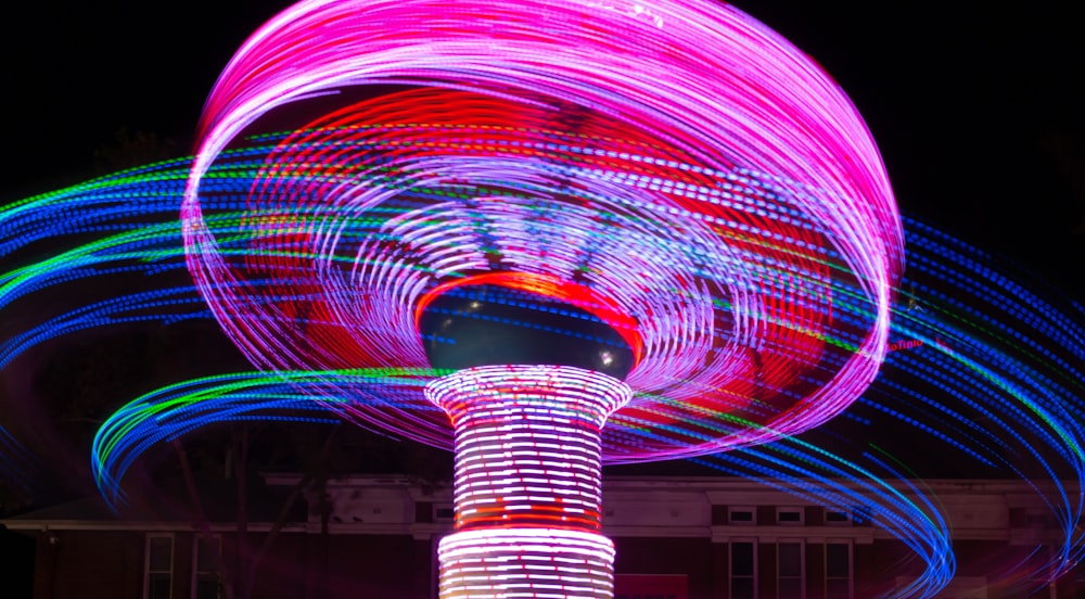 a ferris wheel is lit up at night