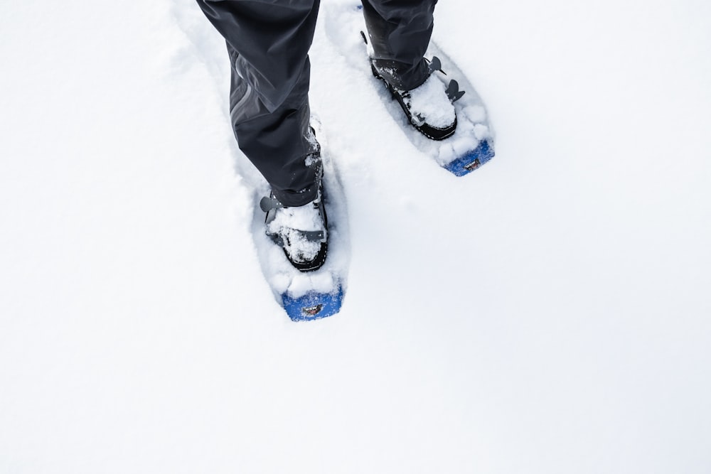 a person wearing skis standing in the snow