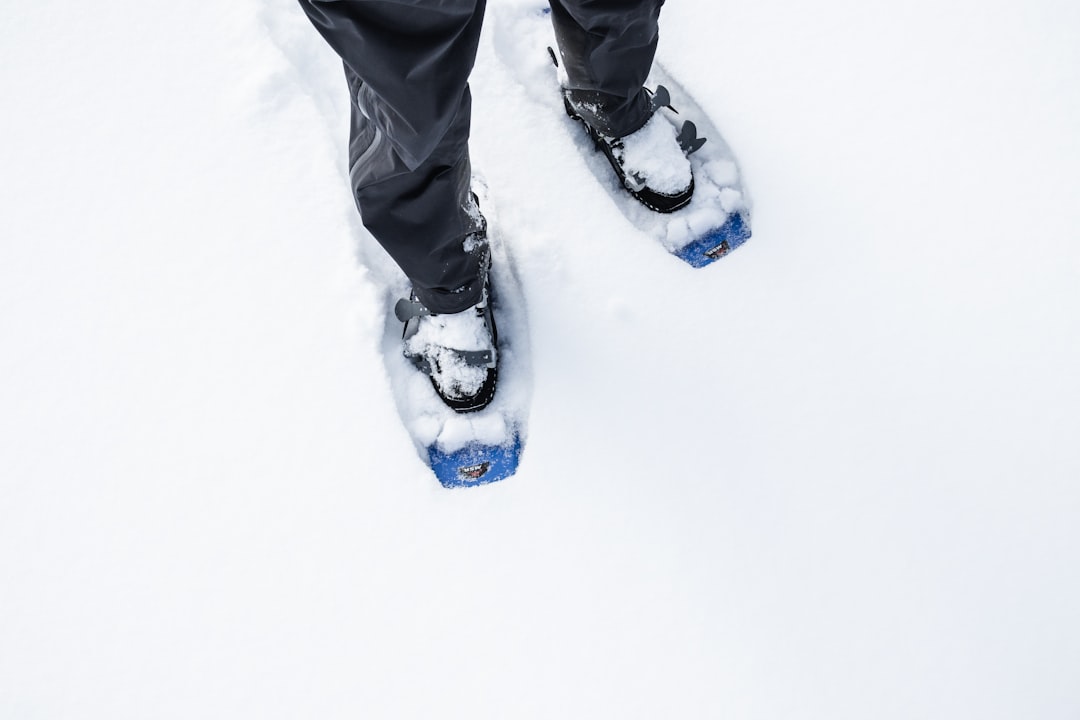 smow white, snowpants, a person wearing skis standing in the snow
