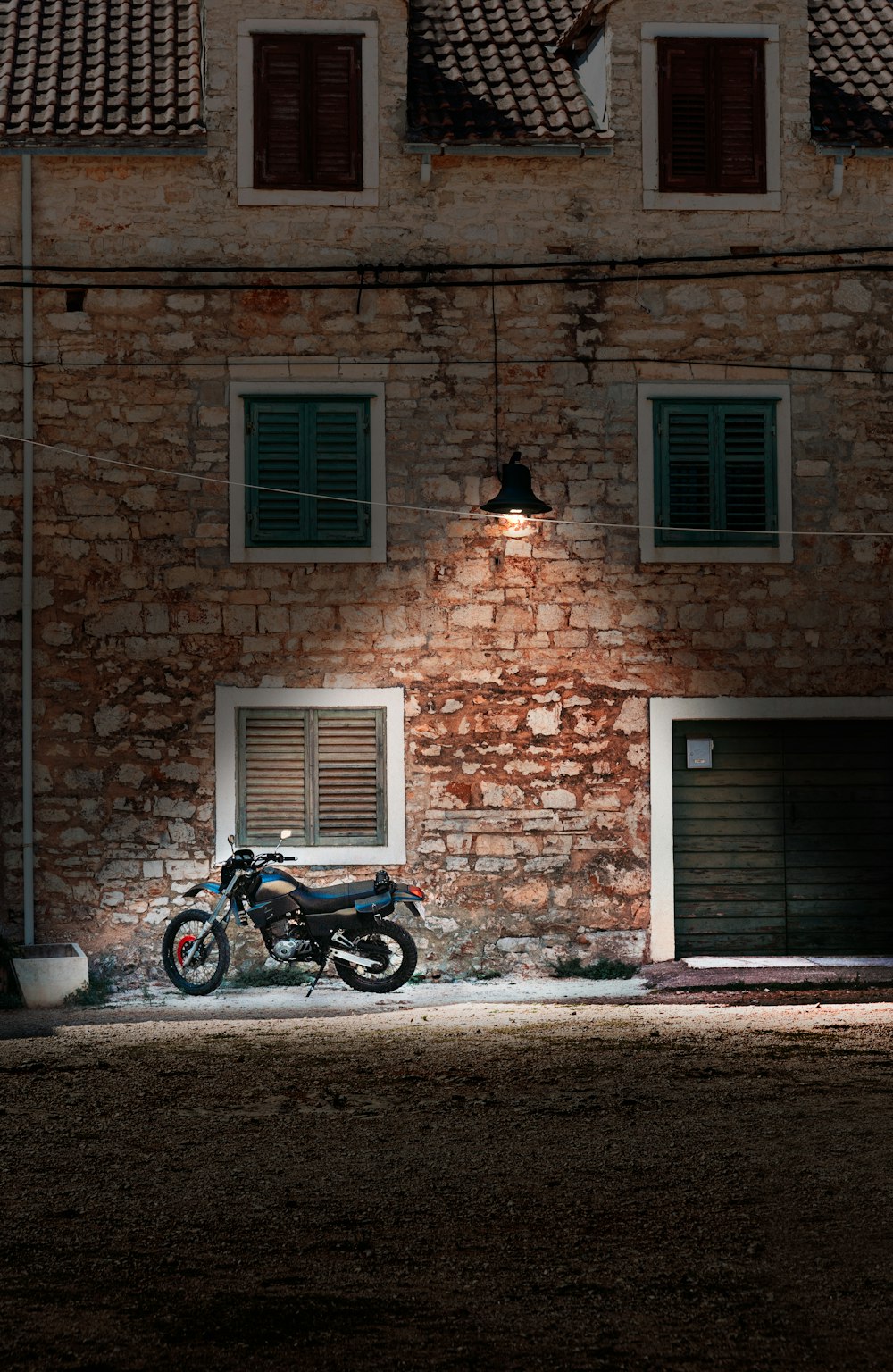 a motorcycle parked in front of a brick building