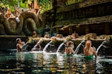 a group of people sitting in a pool of water