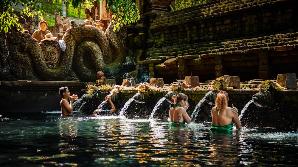 a group of people sitting in a pool of water