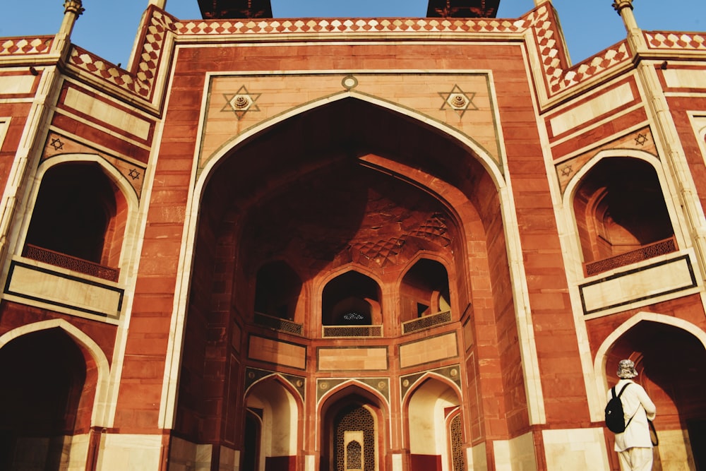 a person standing in front of a large building