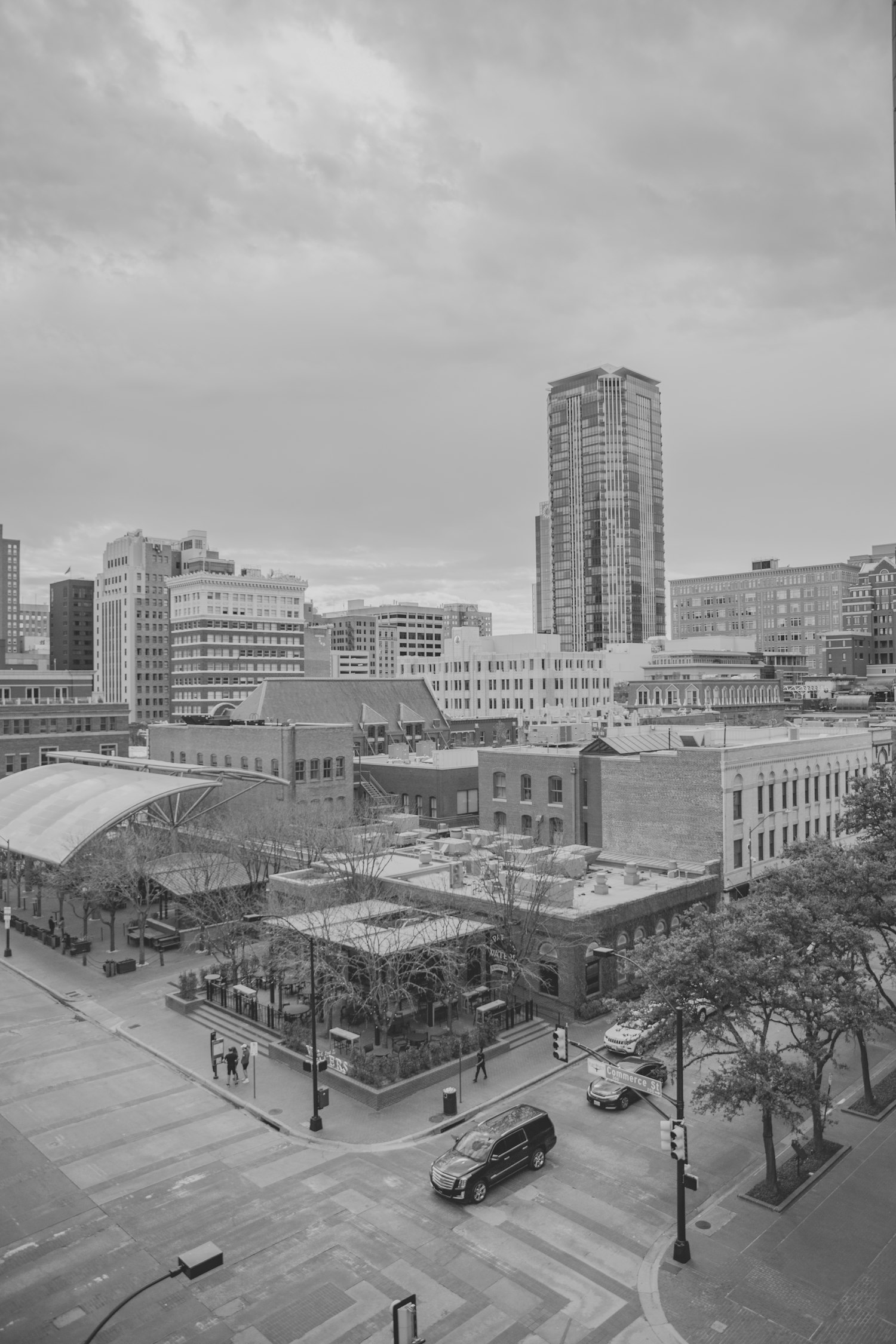 a view of a city with tall buildings by Fallon Michael