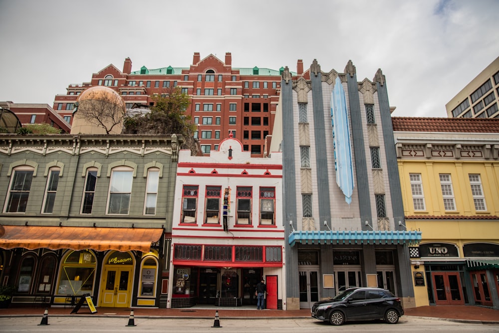 a car is parked in front of a row of buildings