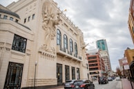 Bass Hall in Downtown Fort Worth; a city street with cars parked on the side of it