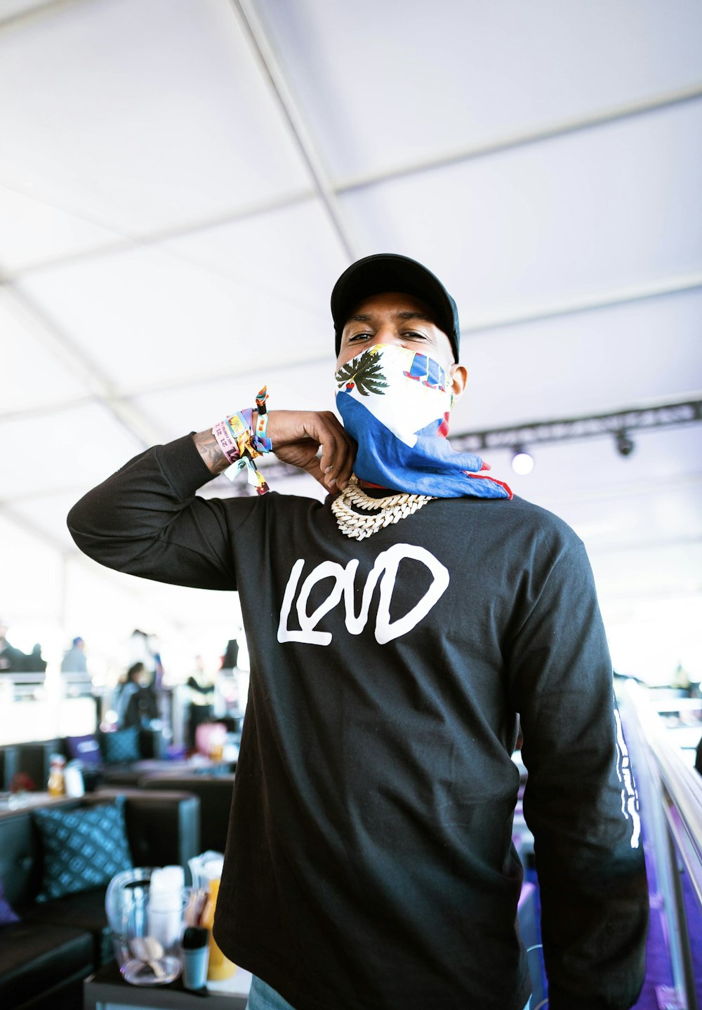 a man wearing a face mask while standing under a tent