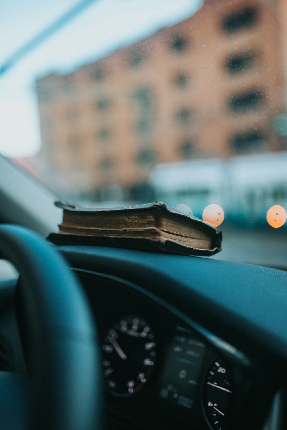 a book is sitting on the dashboard of a car