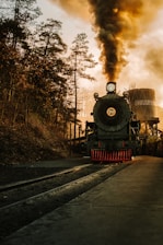 a steam engine train traveling down train tracks