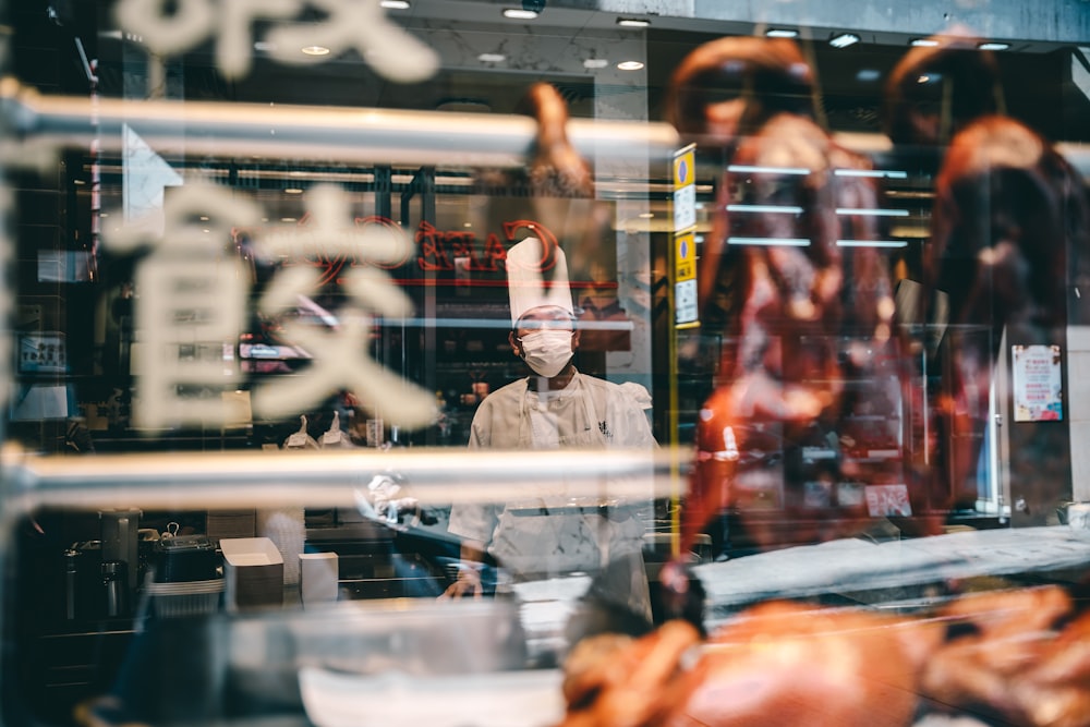 a man standing in front of a butcher shop
