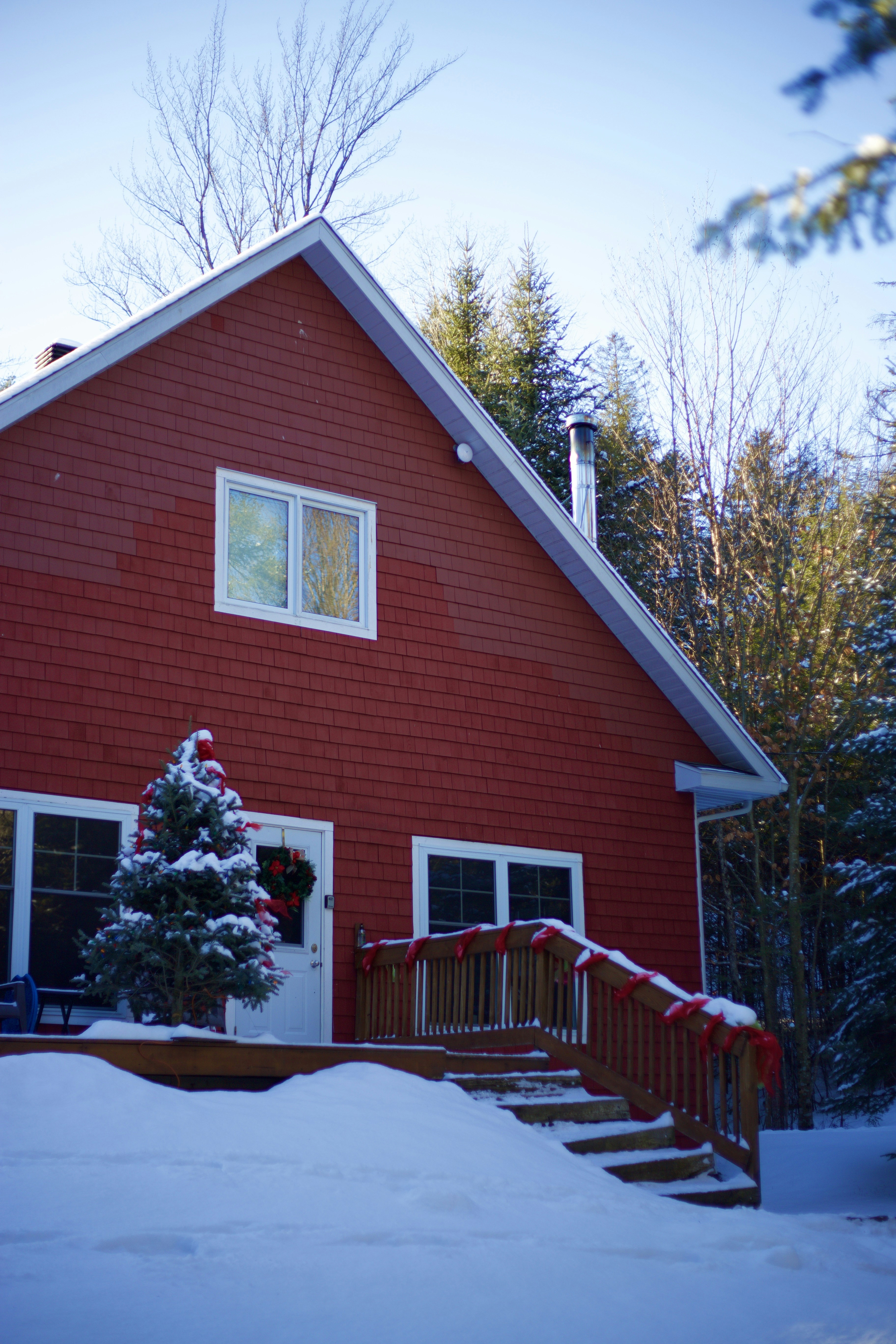 a red house with snow on the ground