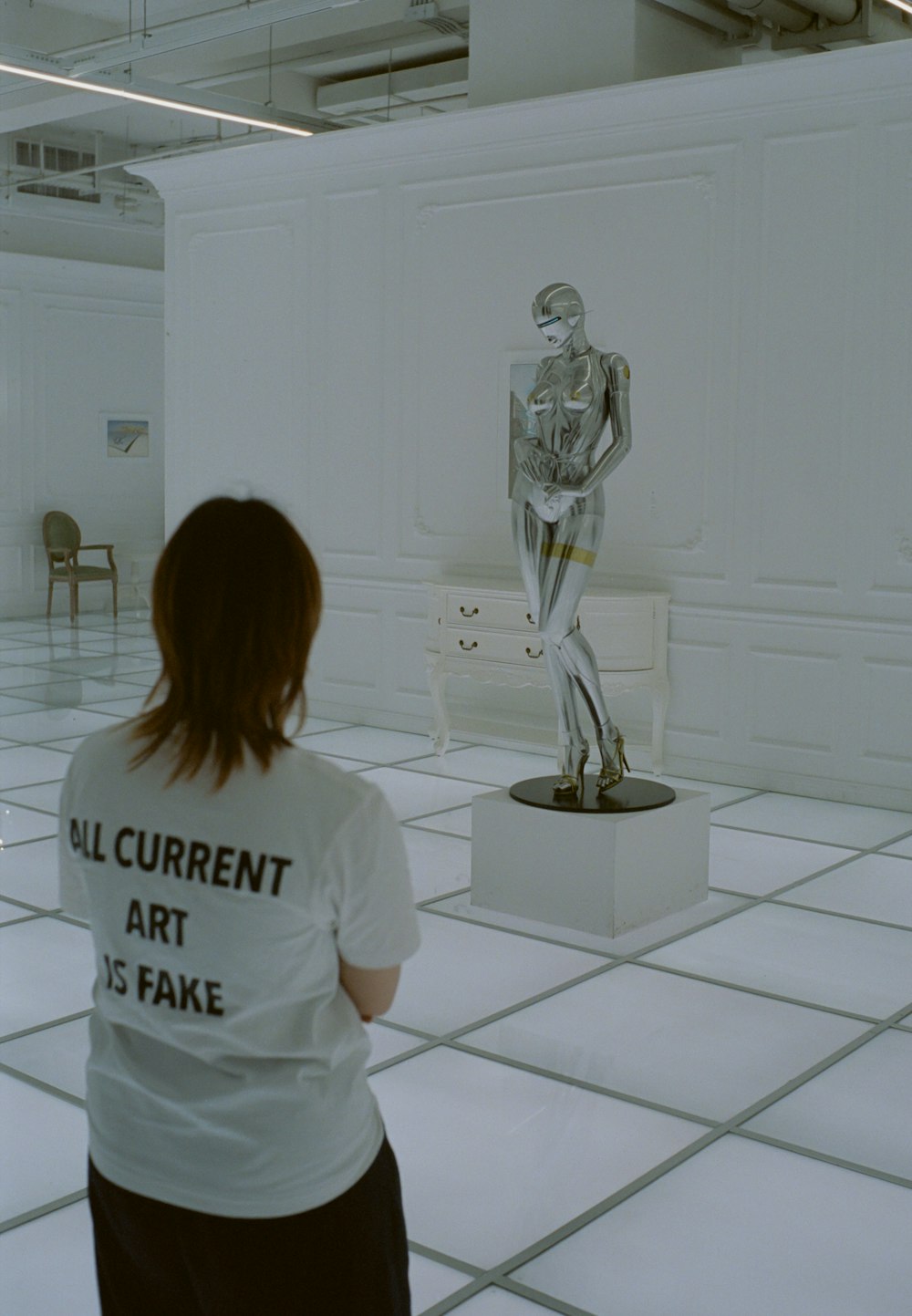 a woman is looking at a sculpture in a museum