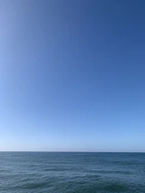 Open waters stretching to the horizon under a clear blue sky, evoking peace and clarity.