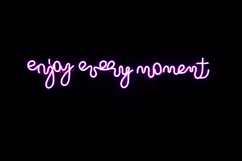 a neon sign that says, enjoy every moment