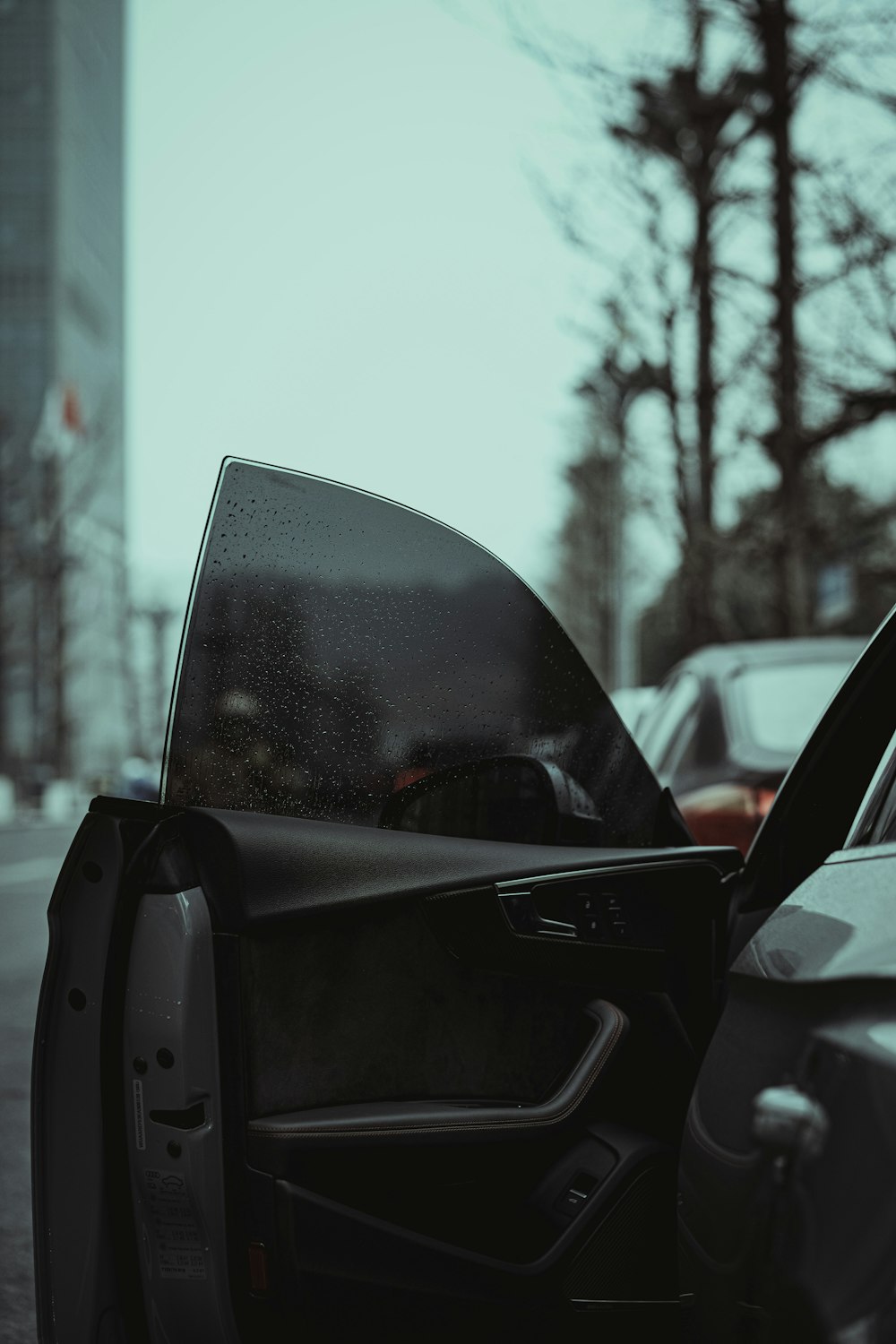 a car with its door open on a city street