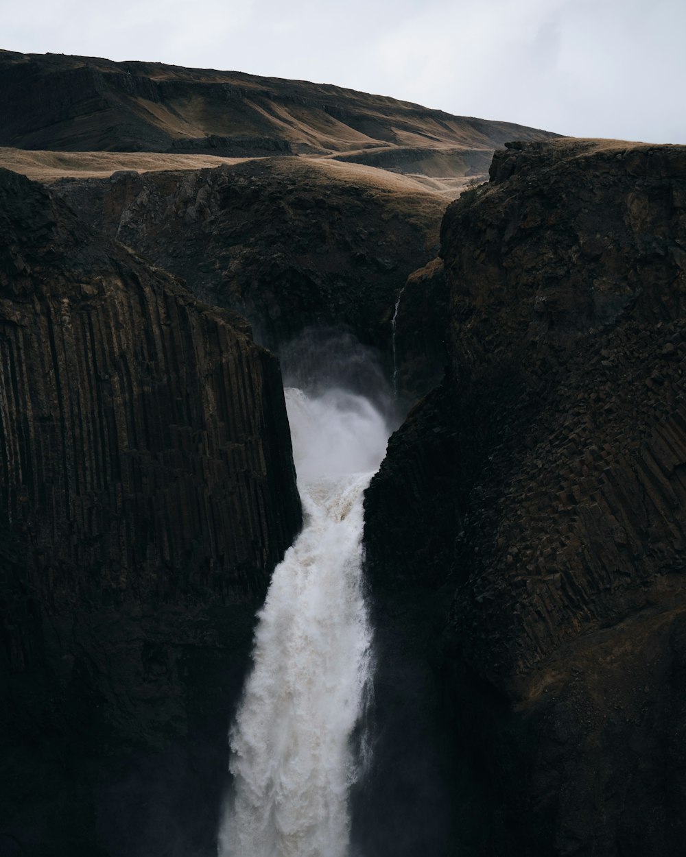 a large waterfall with water coming out of it