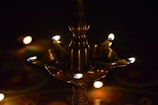 Close-up of a finely detailed brass lamp glowing warmly in a cozy room.