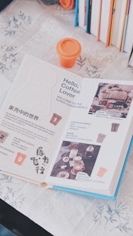 A stylish open booklet featuring maps and notes beside a cup of artisan coffee.