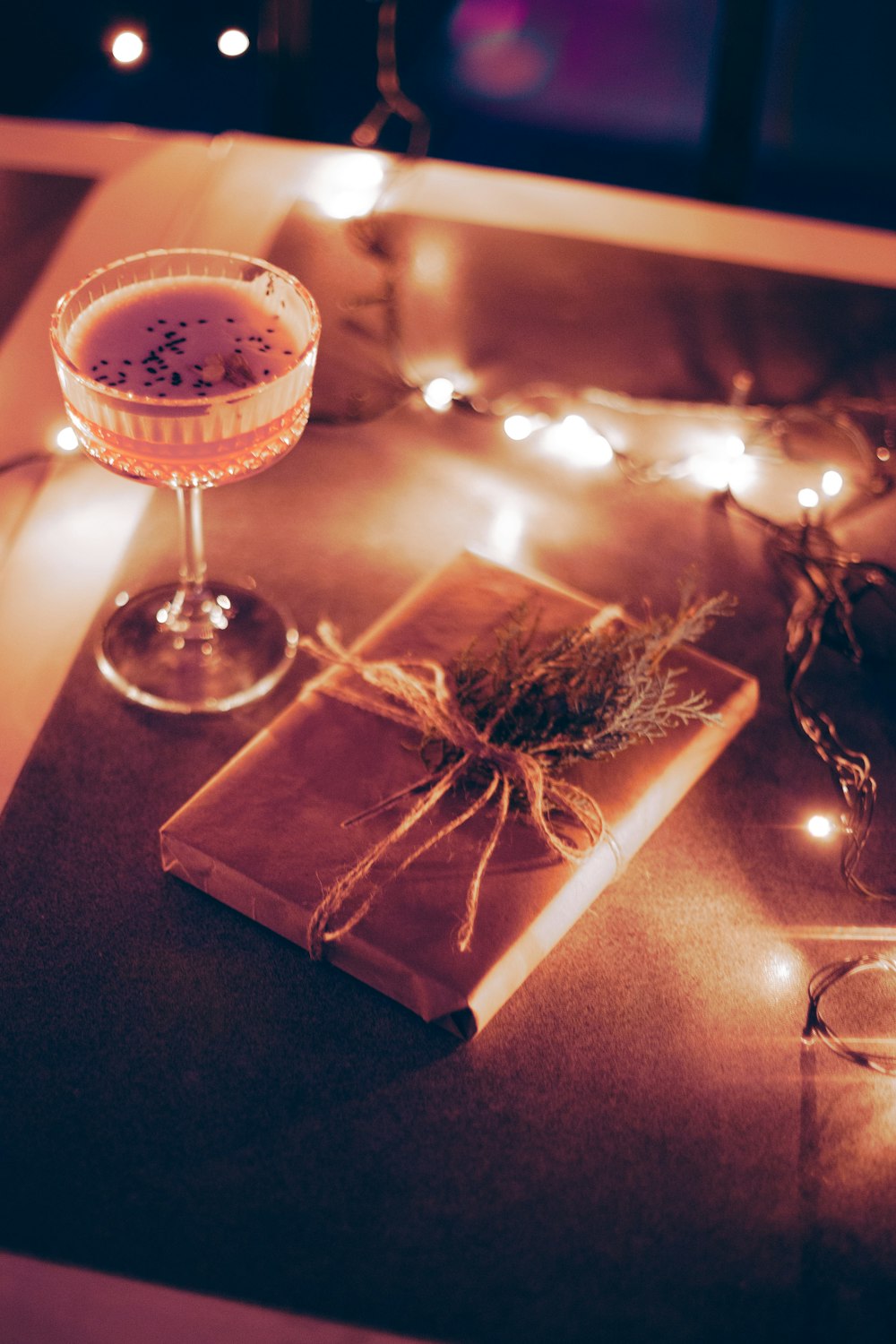 a glass of wine sitting on top of a table