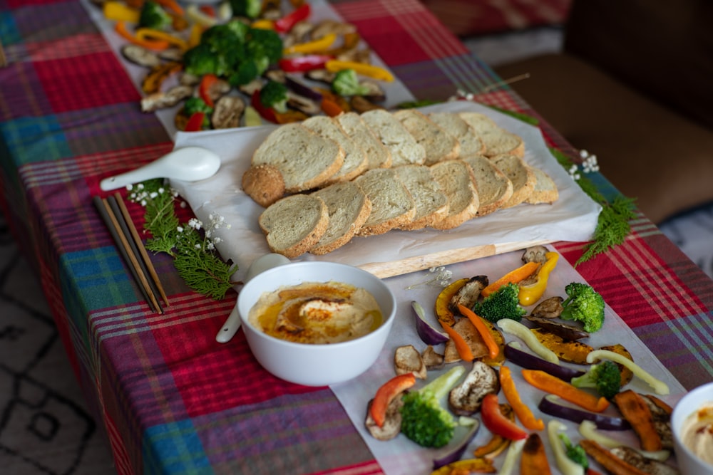 a table topped with plates of food and bowls of soup