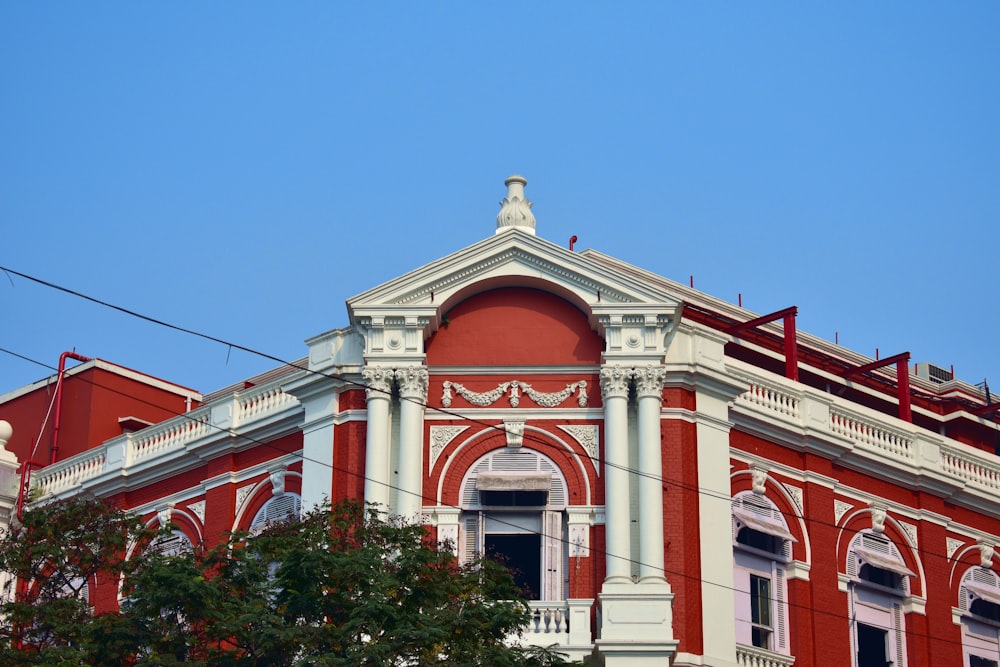 a red and white building with a clock on top