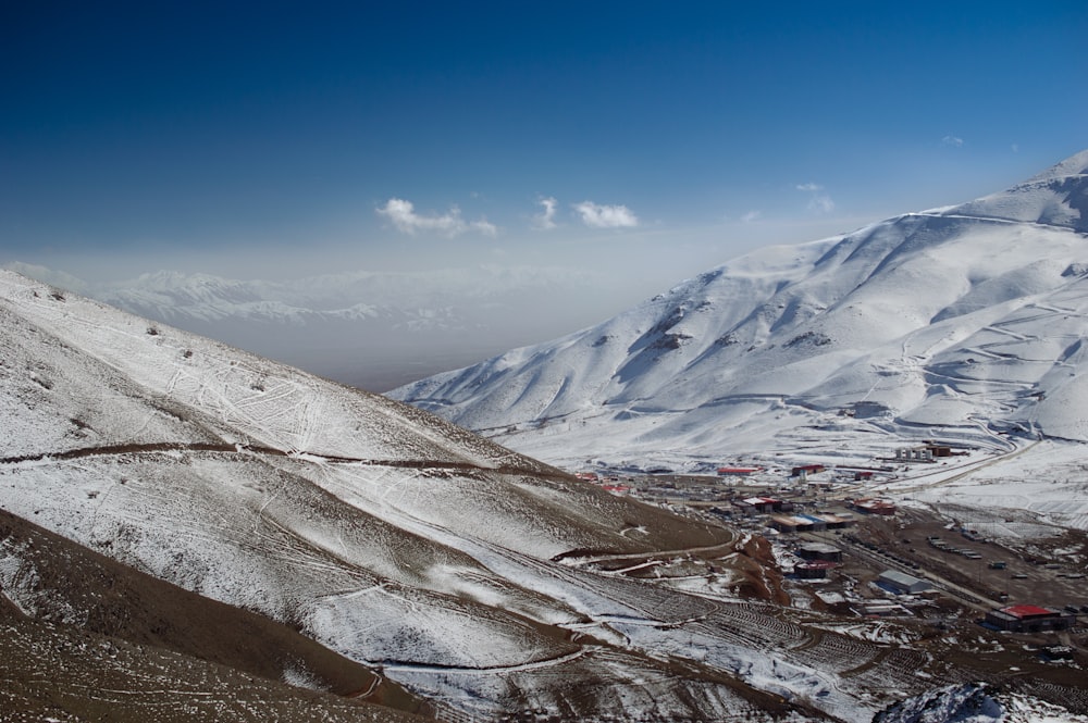 a snow covered mountain with a road going through it