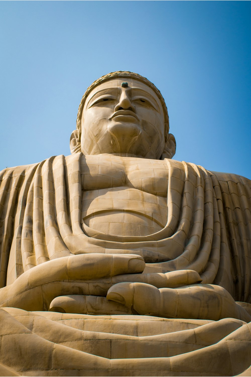 a large statue of a person with his arms crossed