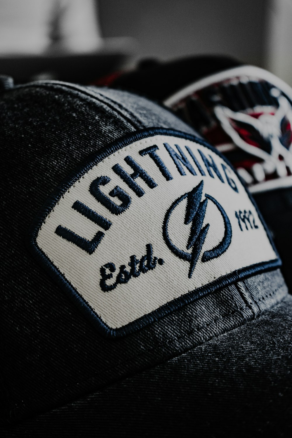 a black hat with a lightning patch on it