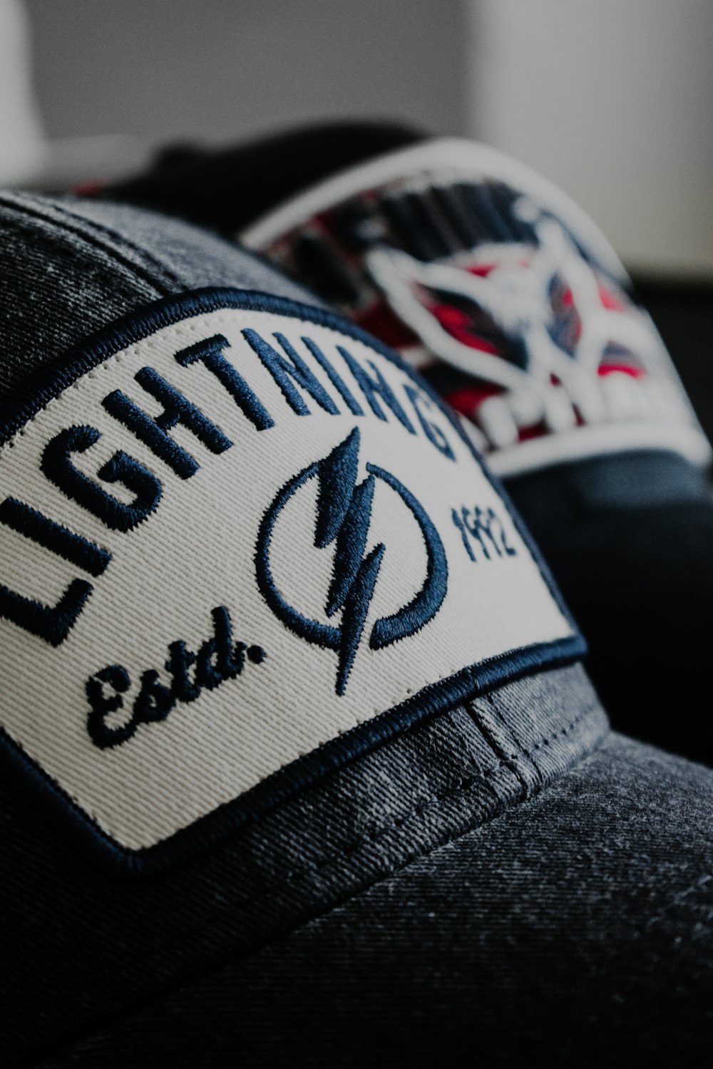 a close up of a hat with a lightning logo on it