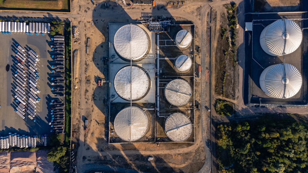 an aerial view of several large white tanks