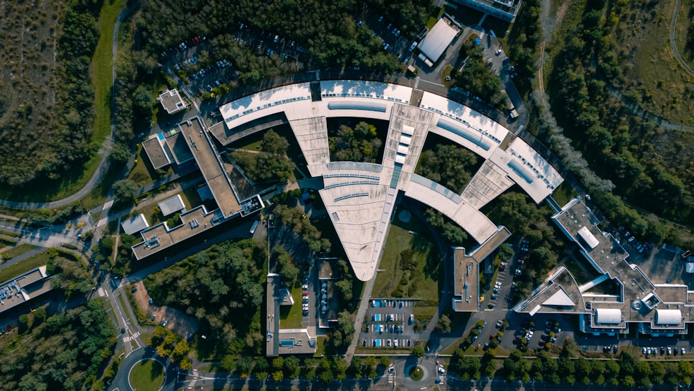 an aerial view of a circular building surrounded by trees