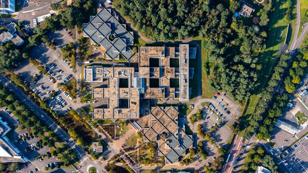 an aerial view of a building in the middle of a park