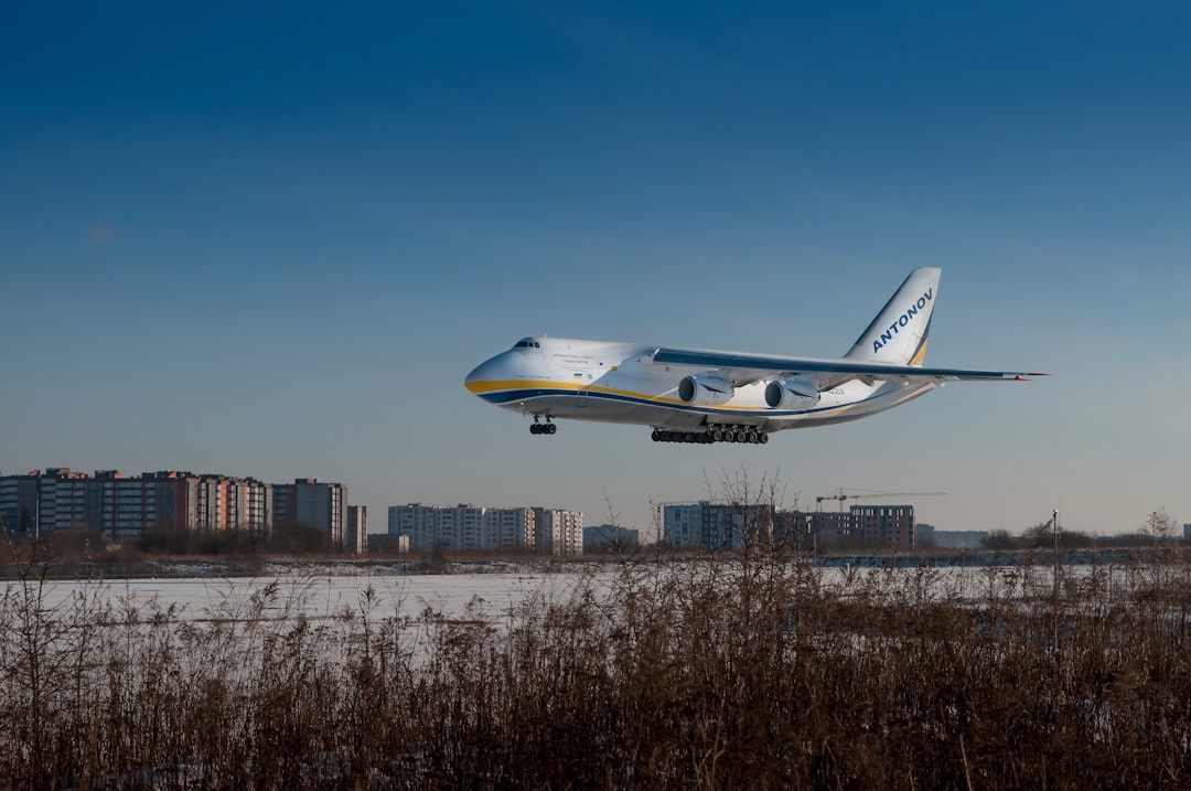 a large jetliner flying through a blue sky, Gigantic beauty Antonov 124