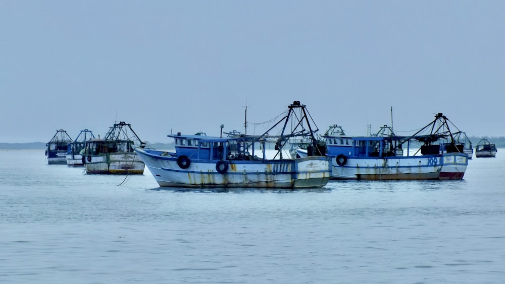 a group of boats floating on top of a large body of water