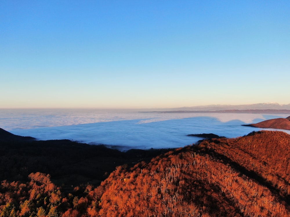 a view of a mountain with low lying clouds in the distance