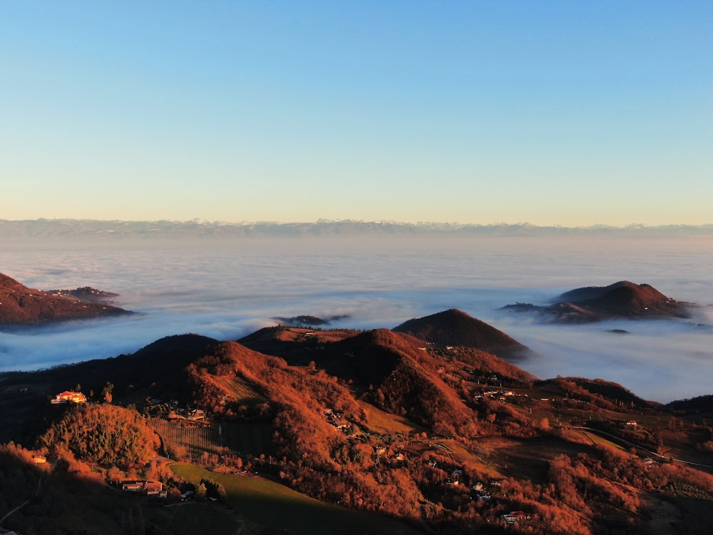 a view of a mountain with low lying clouds